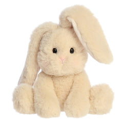 A plush bunny with a hazelnut cream colored coat of fur with one ear up and one ear down