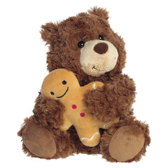 Brown teddy bear plush holding a small gingerbread friend