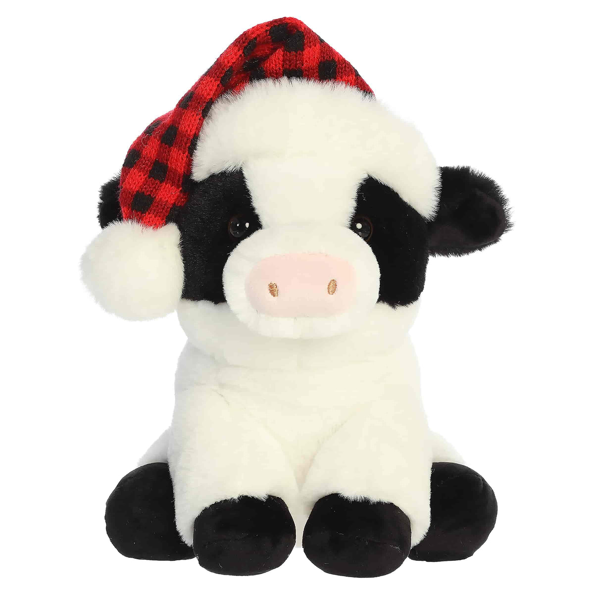 Black and white cow plush wearing a red plaid holiday hat