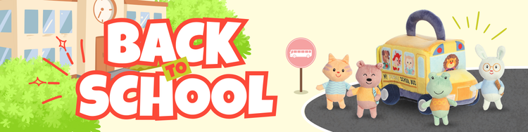 Back to school banner with plush animals near a school bus and stop sign.