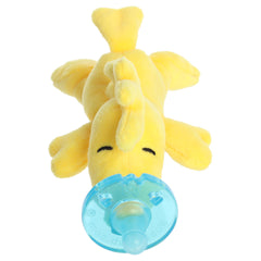 A Woodstock WubbaNub pacifier plush from Aurora with Woodstock attached to a baby pacifier.