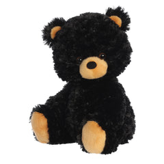 A fluffy stuffed animal black bear cub plush that is in the seated position with extra soft fut and a cute button nose