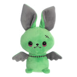 Green zombie bat stuffed animal with eerie grey ears and tiny wings. Embroidered stitch marks around the neck and head