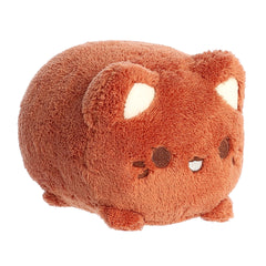 A coconut brown Tasty Peach Meowchi plush that is a round cylinder shape with the resemblance of an animated happy cat.