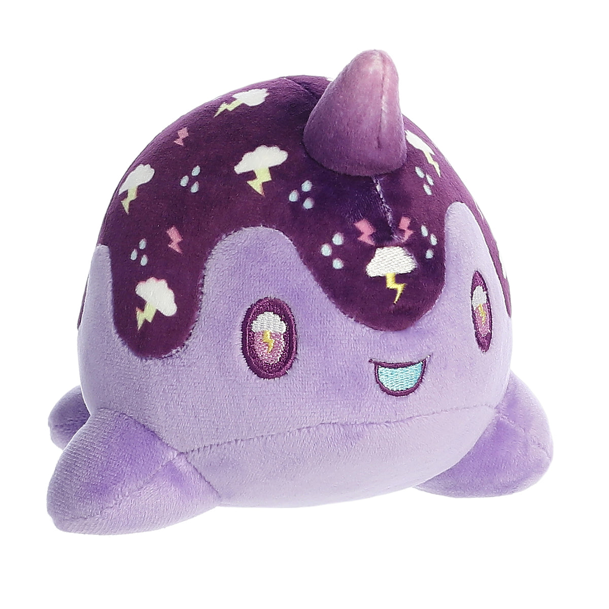 A blend of dark and light purple Tasty Peach Nomwhal plush that is an expressive narwhal with big sparkling embroidered eyes
