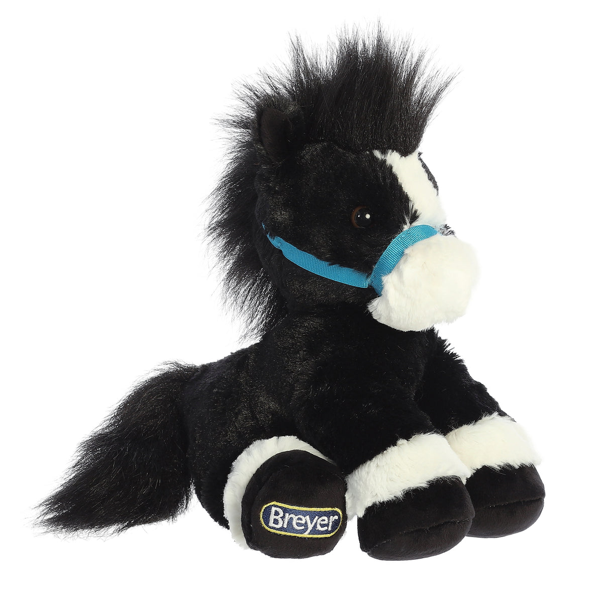An adorably seated black and white Breyer black horse plush with a black coat, a white snout, and baby blue reigns.