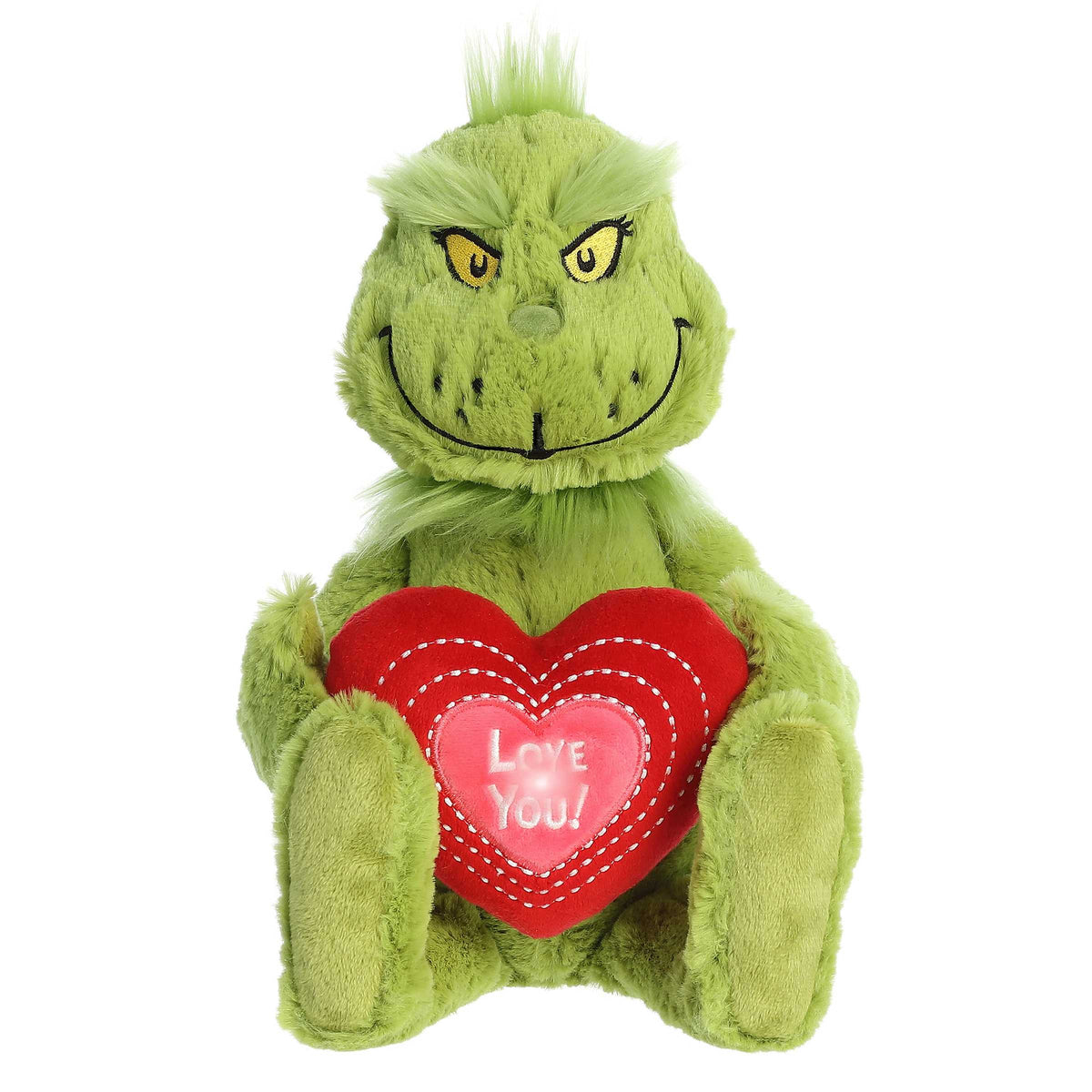 Dr. Seuss Grinch plush holding a light-up 'Love You' heart in its lap, in the seated position with a devious Grinch smile.