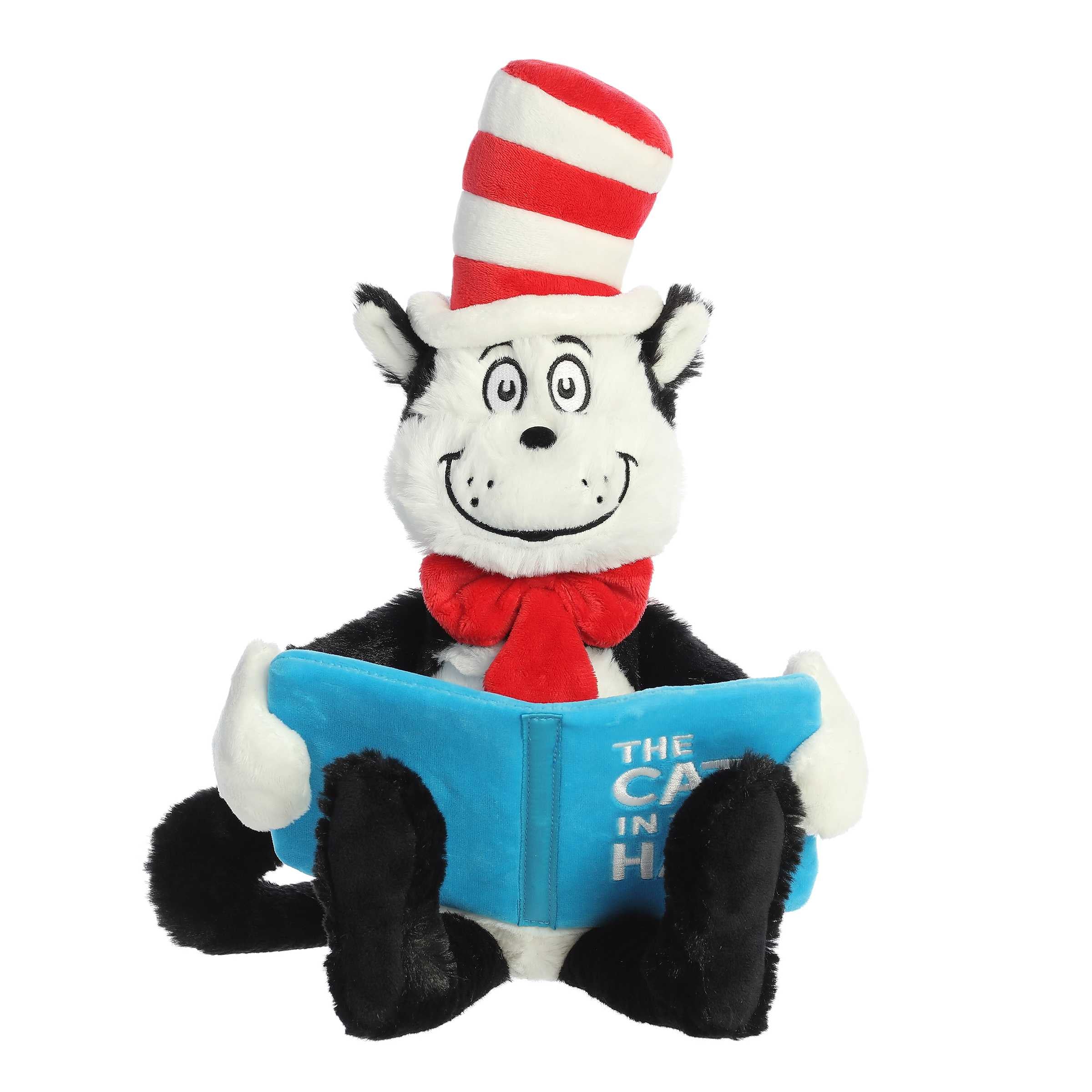 Soft and cuddly Cat in the Hat Plush Toy with signature striped hat, sitting down holding a blue book.