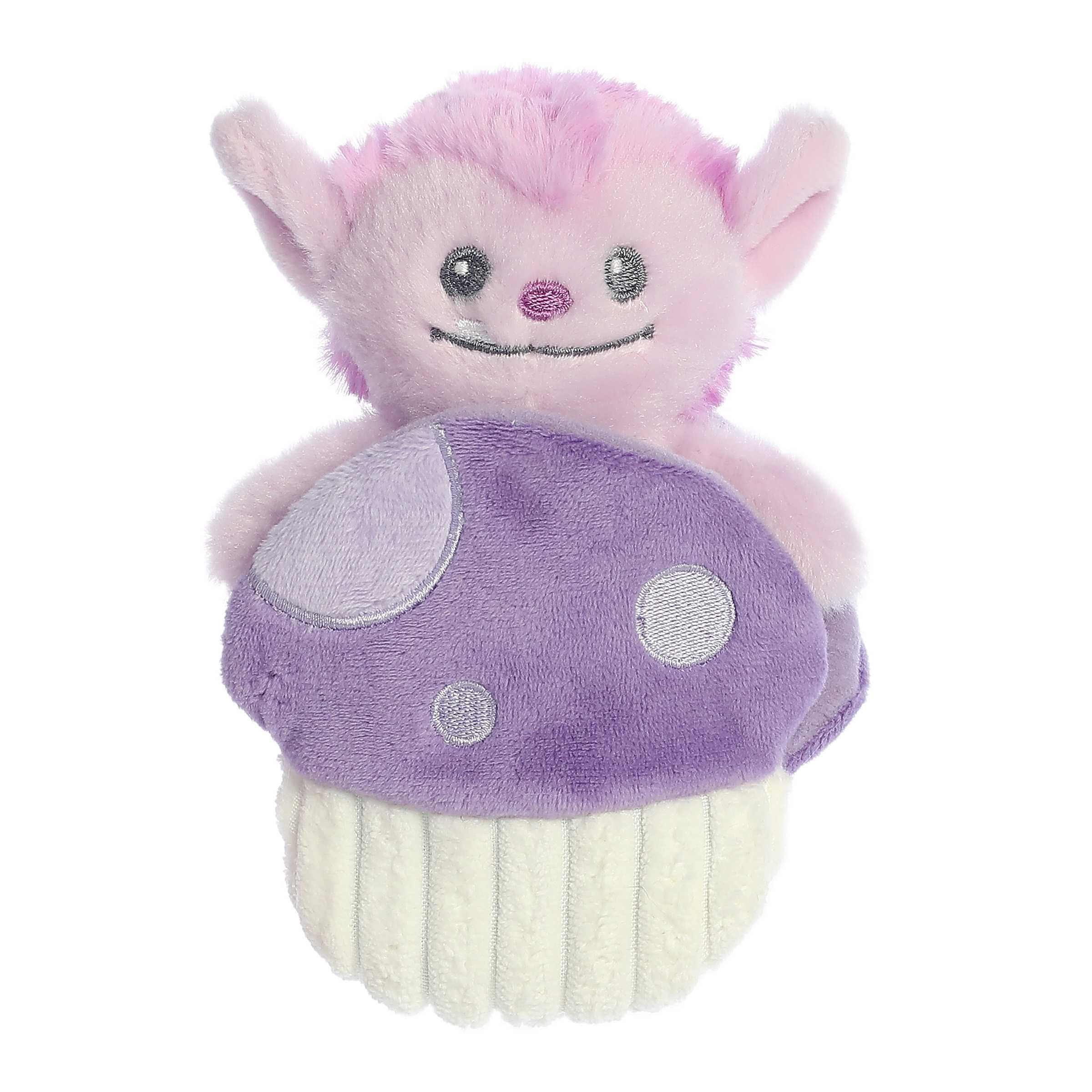 Interactive mini purple Ogre plush rattle toy with smiling face sitting inside a crinkly purple mushroom pocket