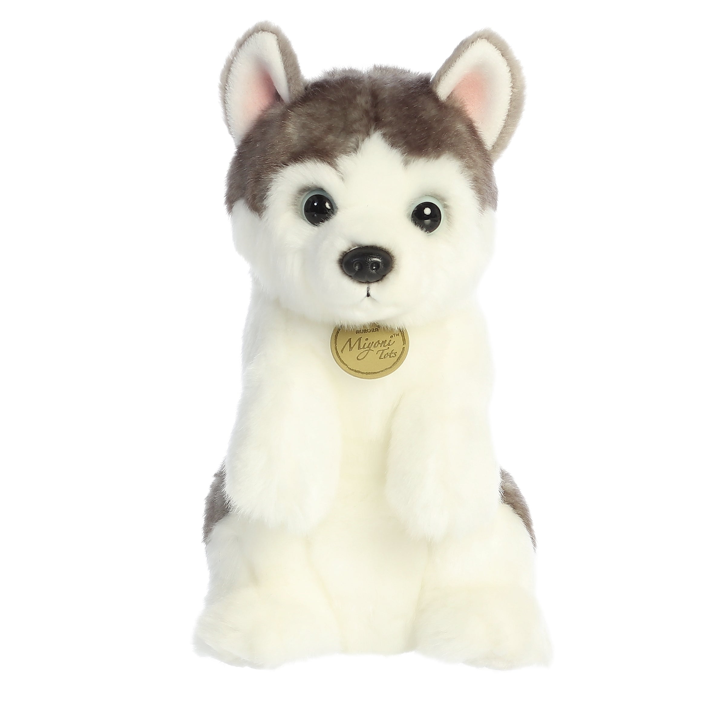 Husky Pup plush with detailed white and gray fur, sitting cheerfully and radiating a spirit of playful curiosity and charm.