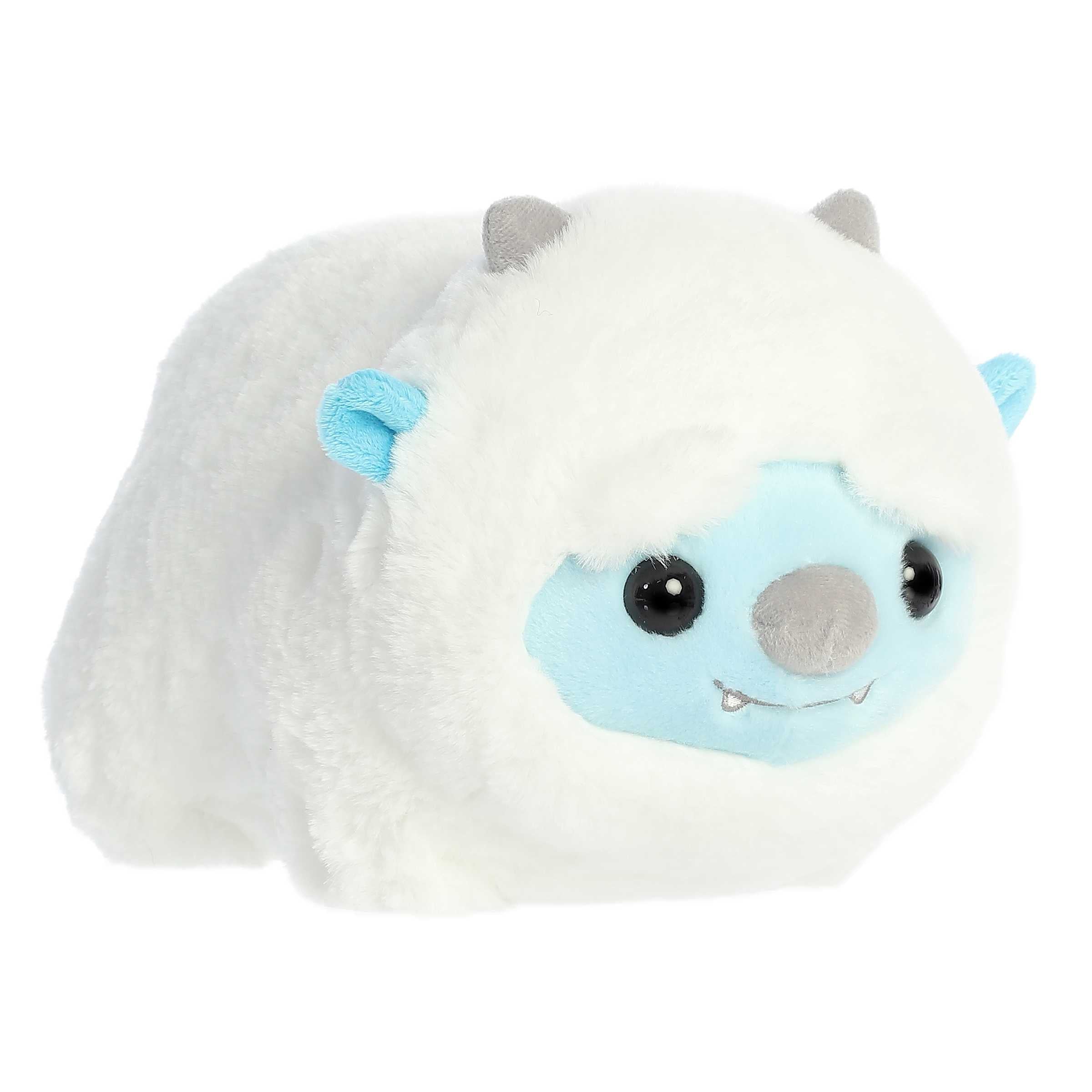 Adorable round white yeti plushie with stubby arms and legs, blue accents on their face and ears, and tiny silver horns.