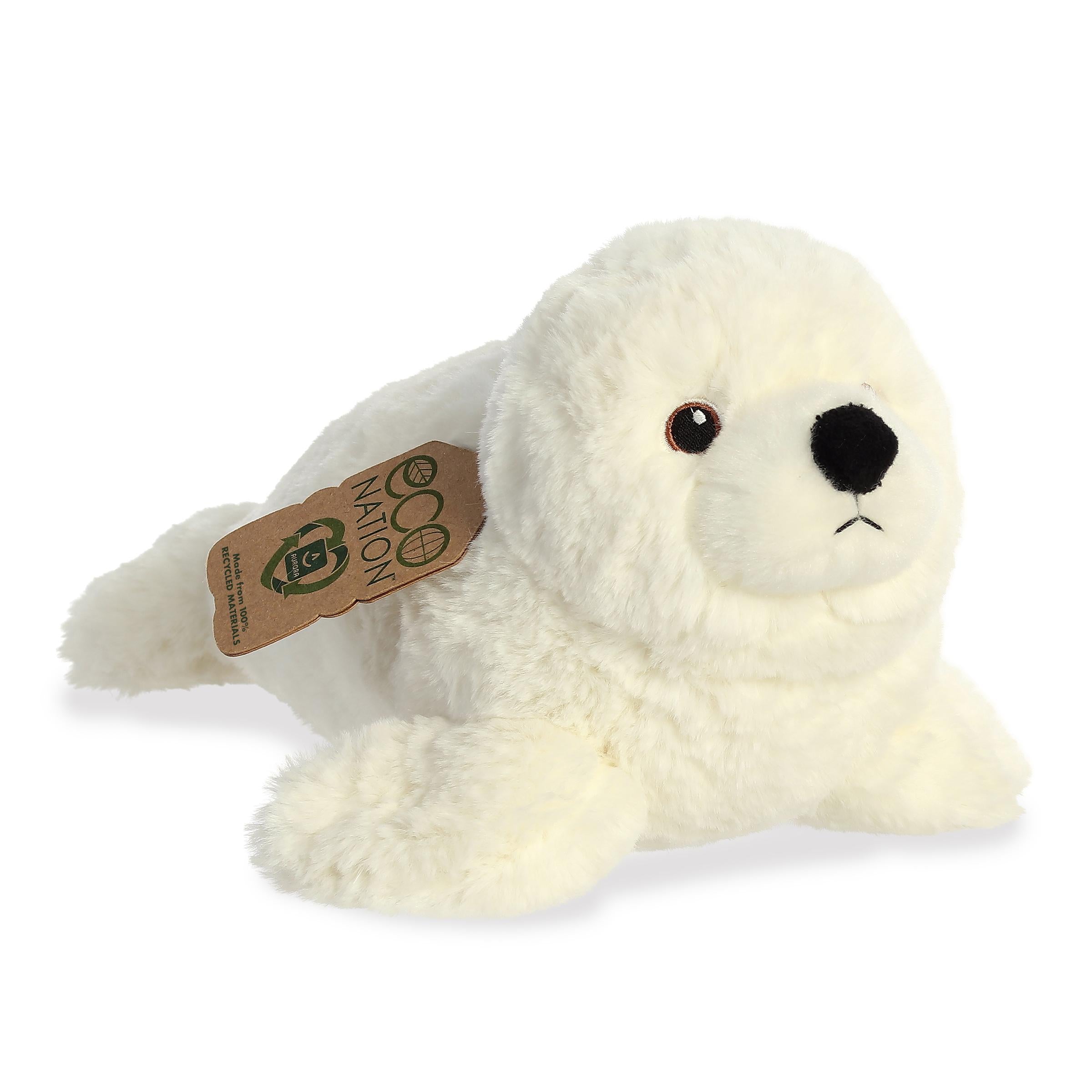 A fluffy seal plush with a pristine white coat, gentle embroidered eyes, and an eco-nation tag hanging from its neck