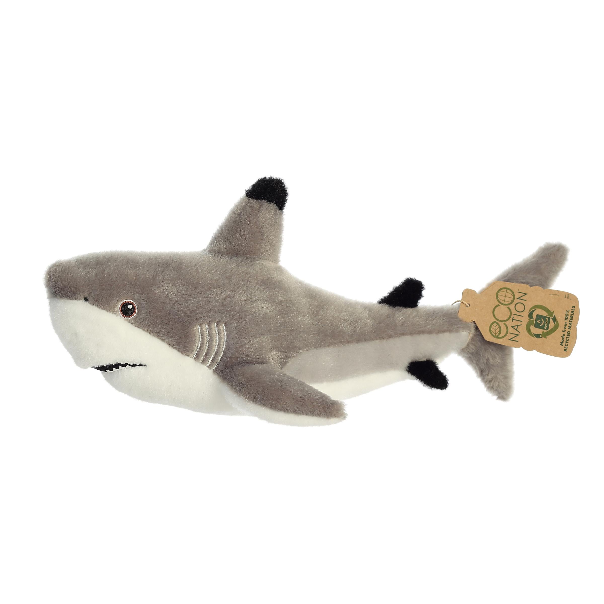 A captivating shark plush with black tips on its fins, detailed embroidered eyes, and an eco-nation tag around its tail