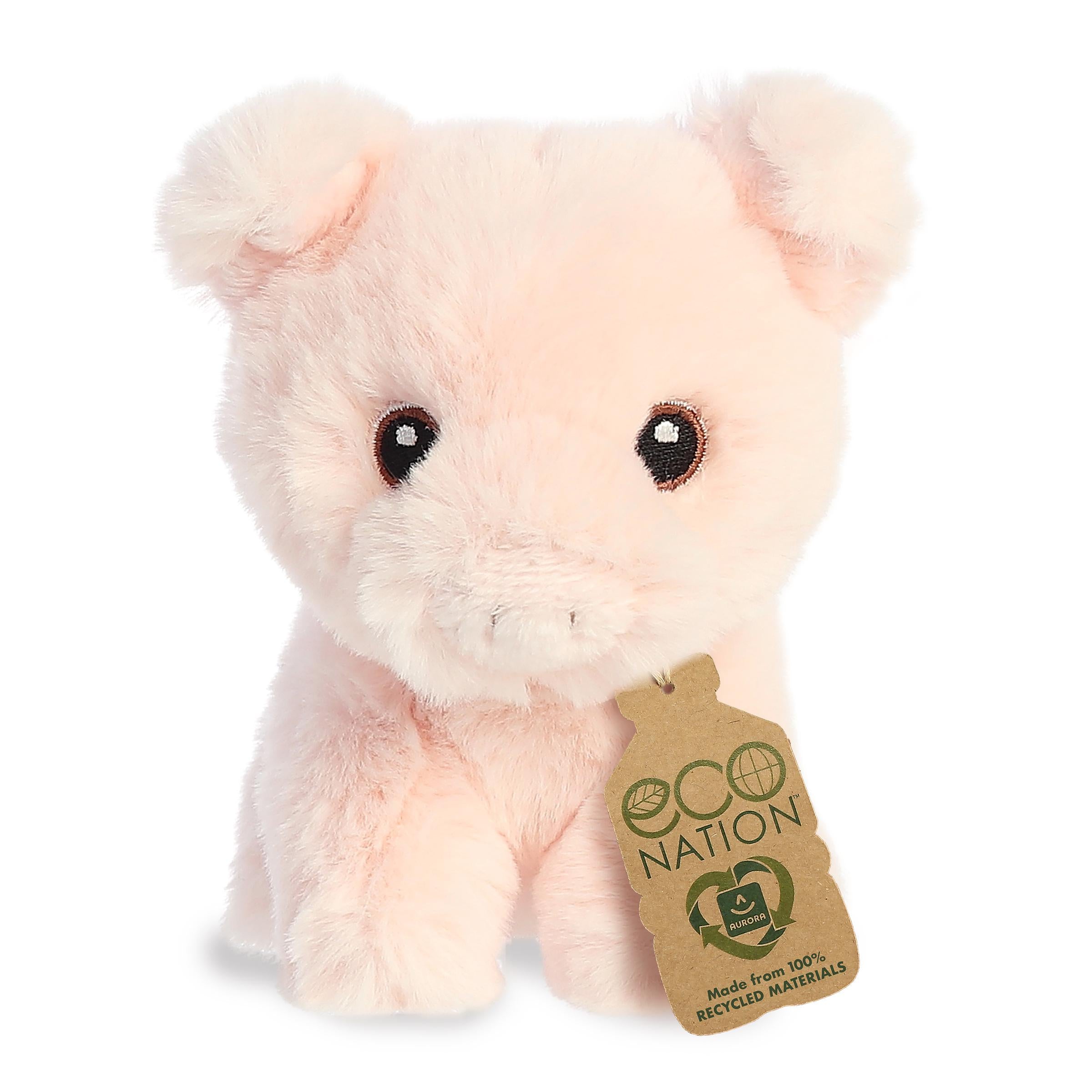 A sweet mini pig plush with a soft fluffy pink coat, delicately embroidered eyes, and a novelty eco-nation tag by its neck