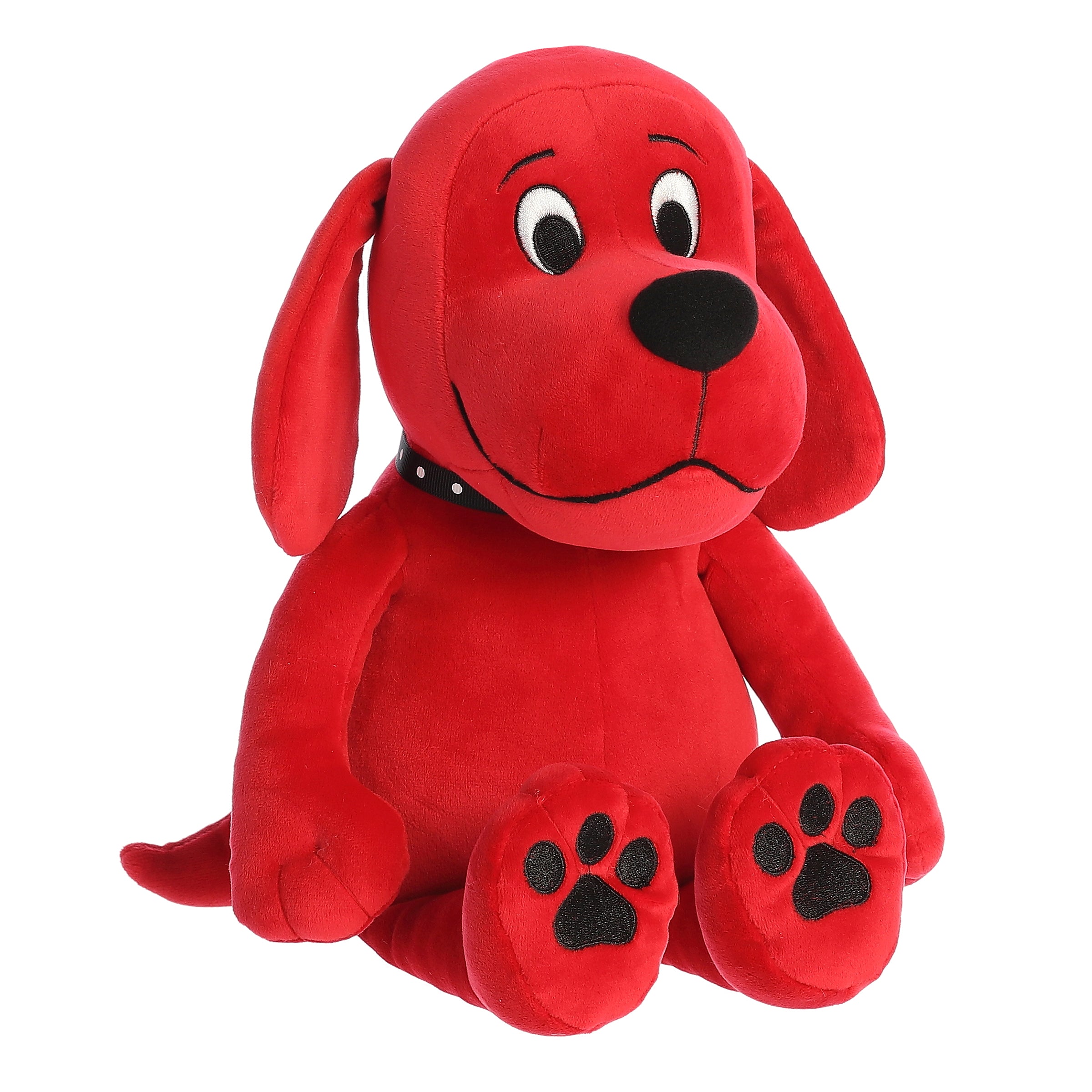 Clifford big red dog plush by Aurora, sporting his iconic red hue and black studded collar, in a patient seated position.