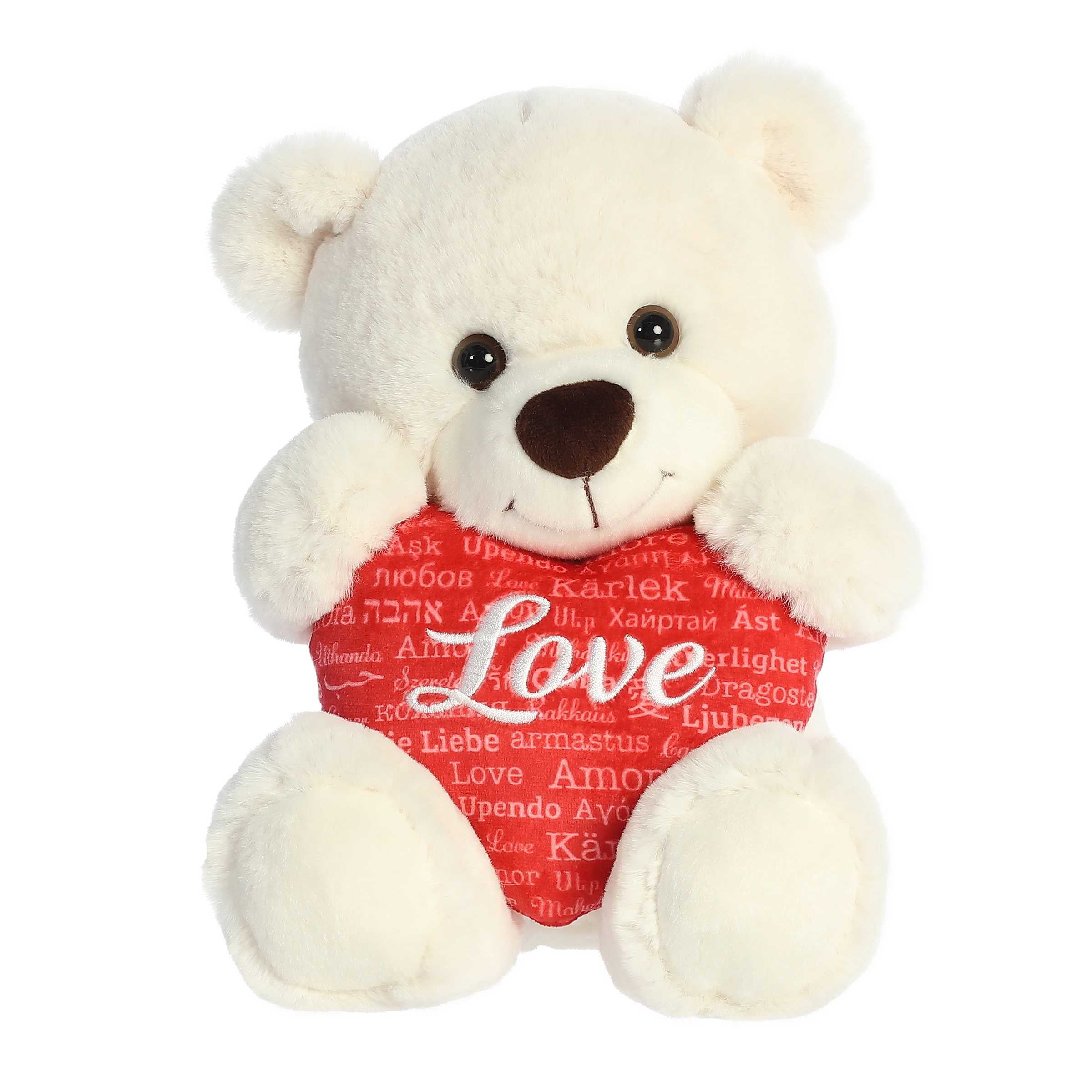 Soft ivory bear plush, holding a red heart with 'Love' in different languages. Symbolizing global affection and unity.