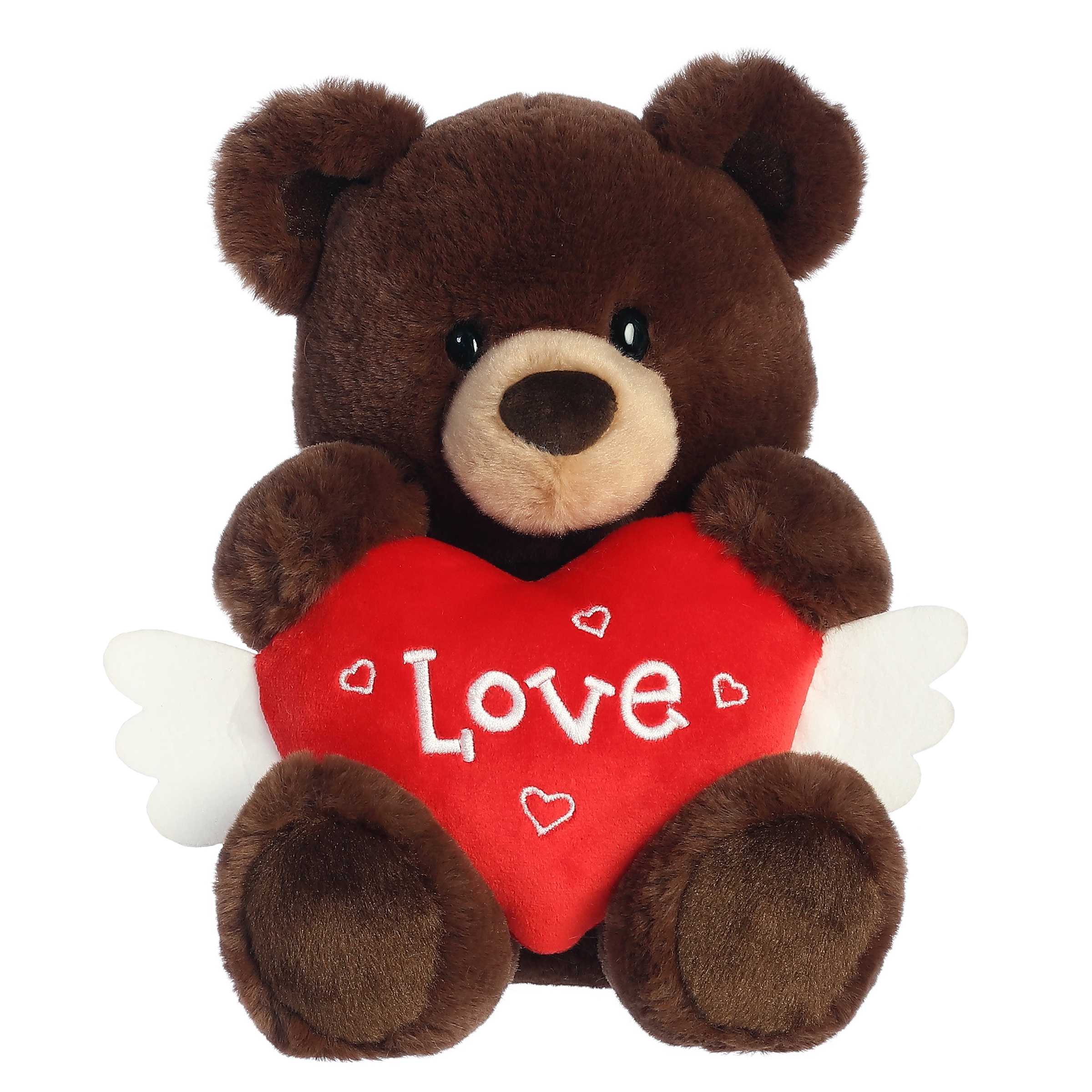 Soft, cream-colored bear plush for Valentine's Day, holding a red heart with white angel wings, embroidered with 'Love'.