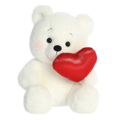 Soft, cream-furred Bashful Bear plush, holding a red heart and blushing, embodying charm and affection for Valentine's Day
