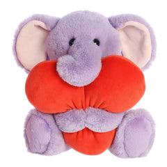 Adora Elephant plush from Heart Huggers, enveloped in purple fur, squeezing an oversized heart, valentine's stuffed animal.