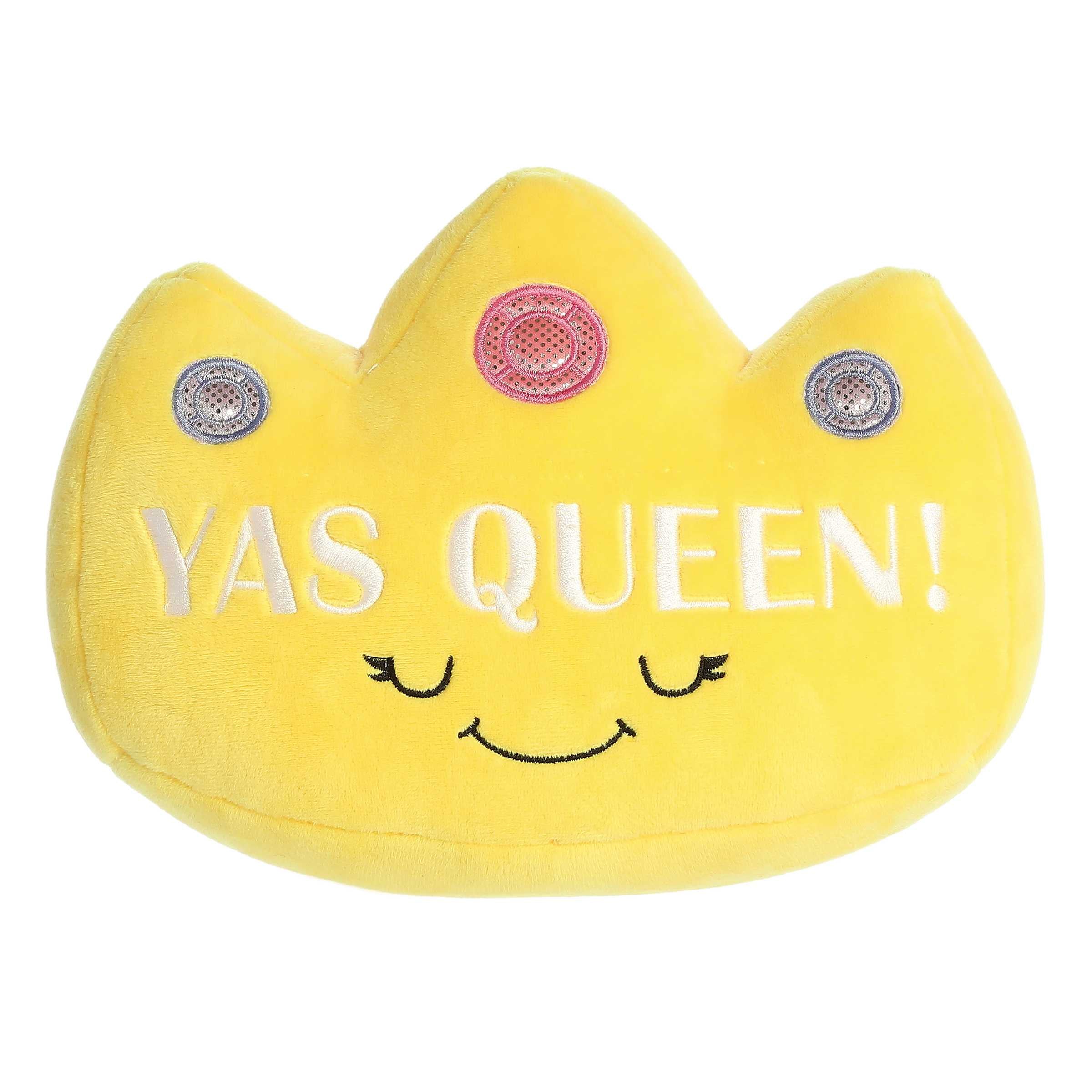 Vibrant yellow plush crown with three embroidered jewels, the phrase 'Yas Queen!', and a happy smiling face from Aurora plush