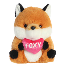 Vibrant orange and white fox plush from Rolly Pets, holding a 'Foxy' heart, in a playful, balanced pose.