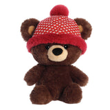 Cozy dark brown teddy bear with large head and big eyes, wearing a red and white beanie for a touch of seasonal charm