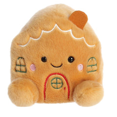 Adorable, happy, mini brown gingerbread house plush toy sitting with embroidered frosting decorations on the front