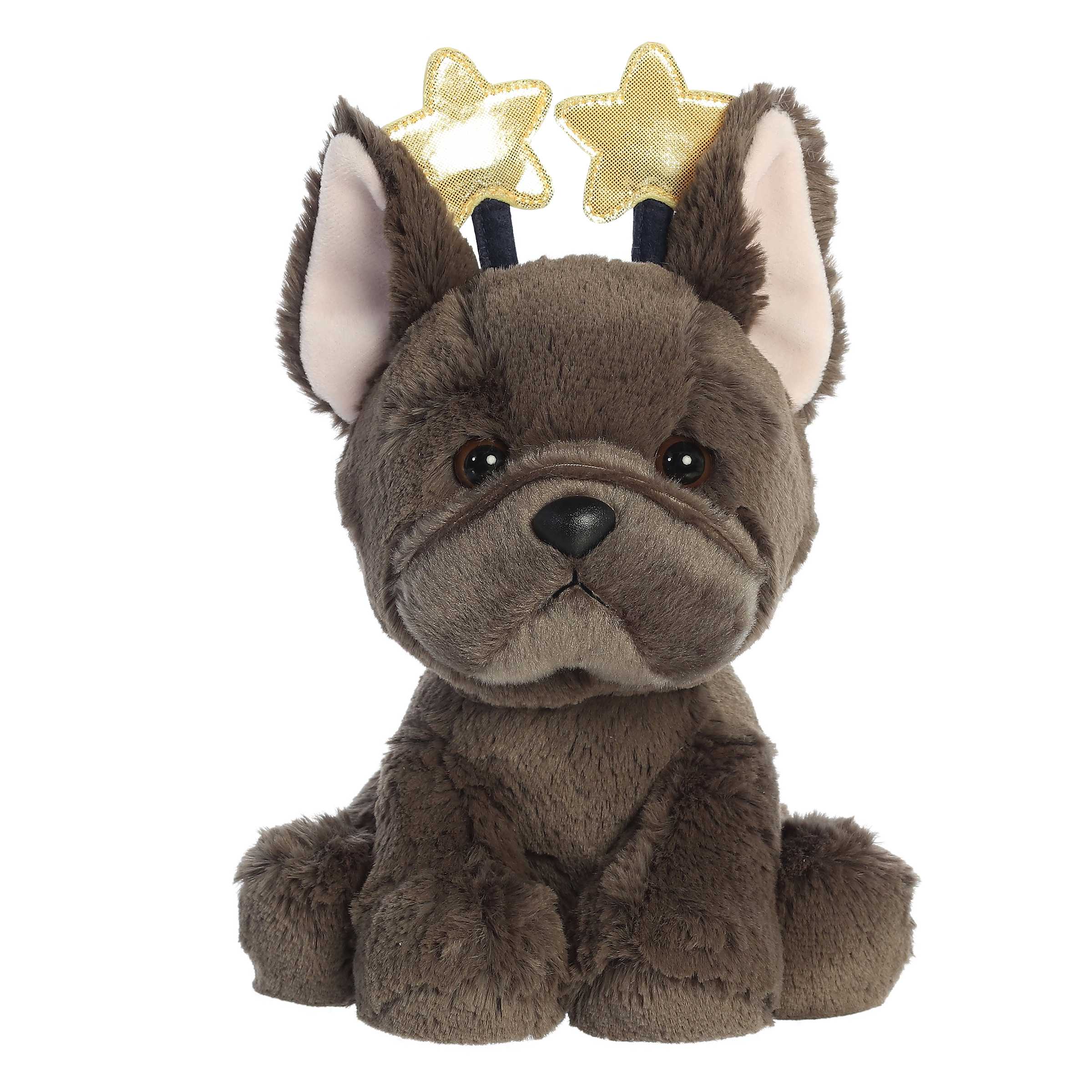 Adorable black French Bulldog in a sitting position wearing a star antenna headband