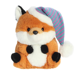 Adorable orange fox with black accents on the ears and stubby hands and feet wearing a pink and blue striped santa hat
